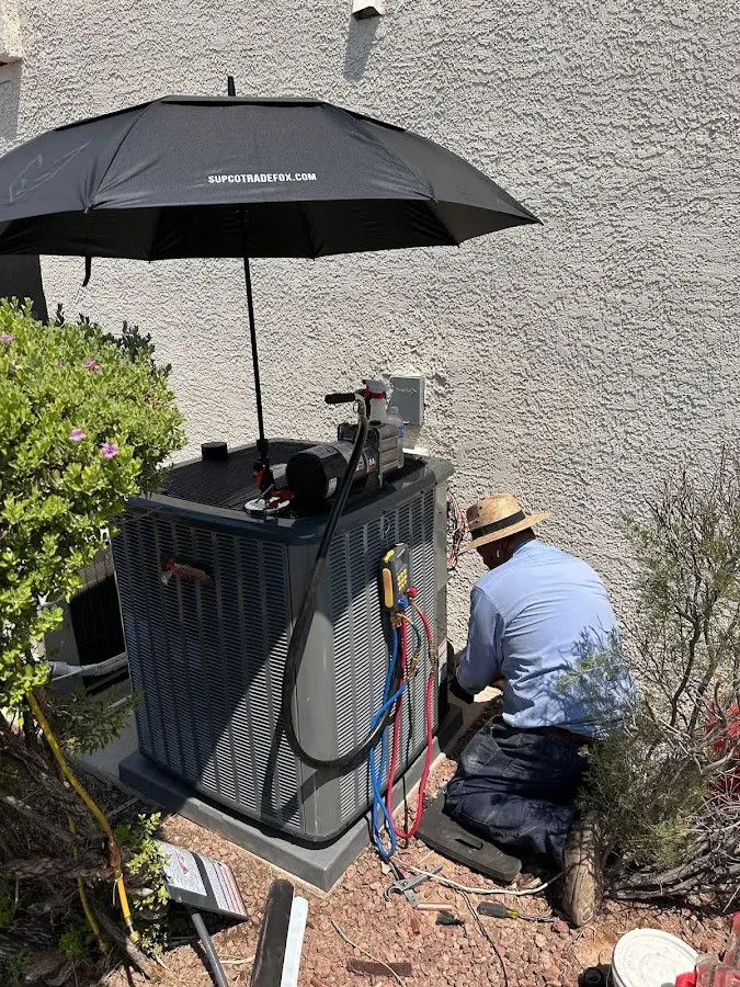 HVAC technician performing outdoor AC maintenance in Suffolk